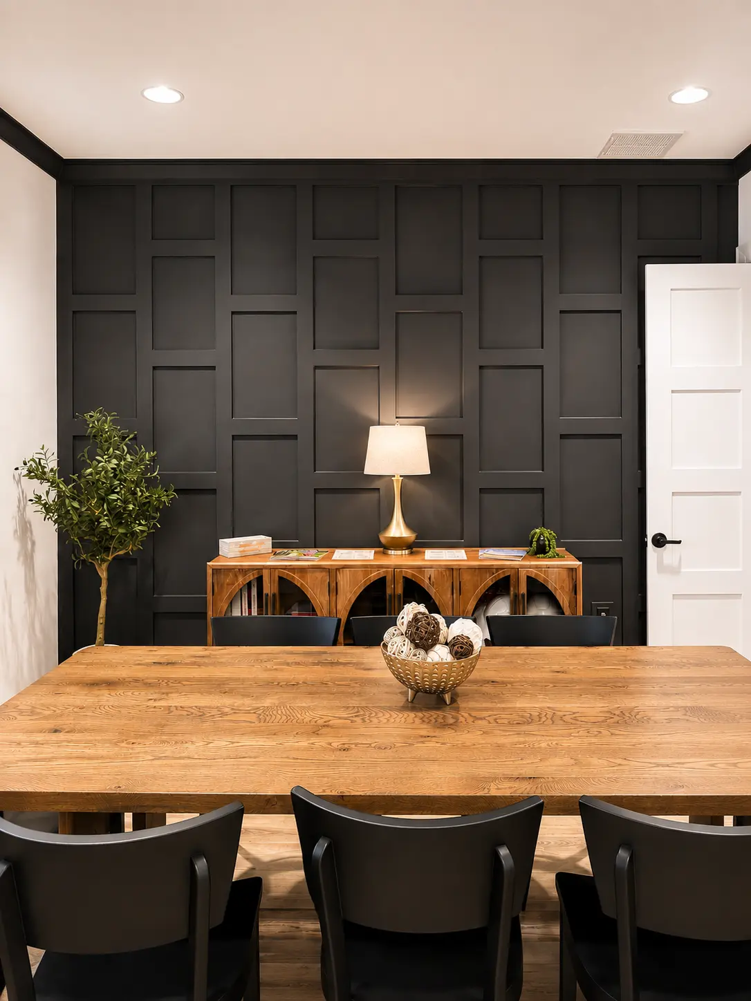 Custom black board-and-batten paneled accent wall in a dining room