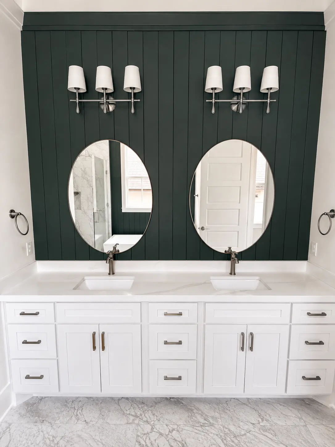 White double vanity against a forest green shiplap wall
