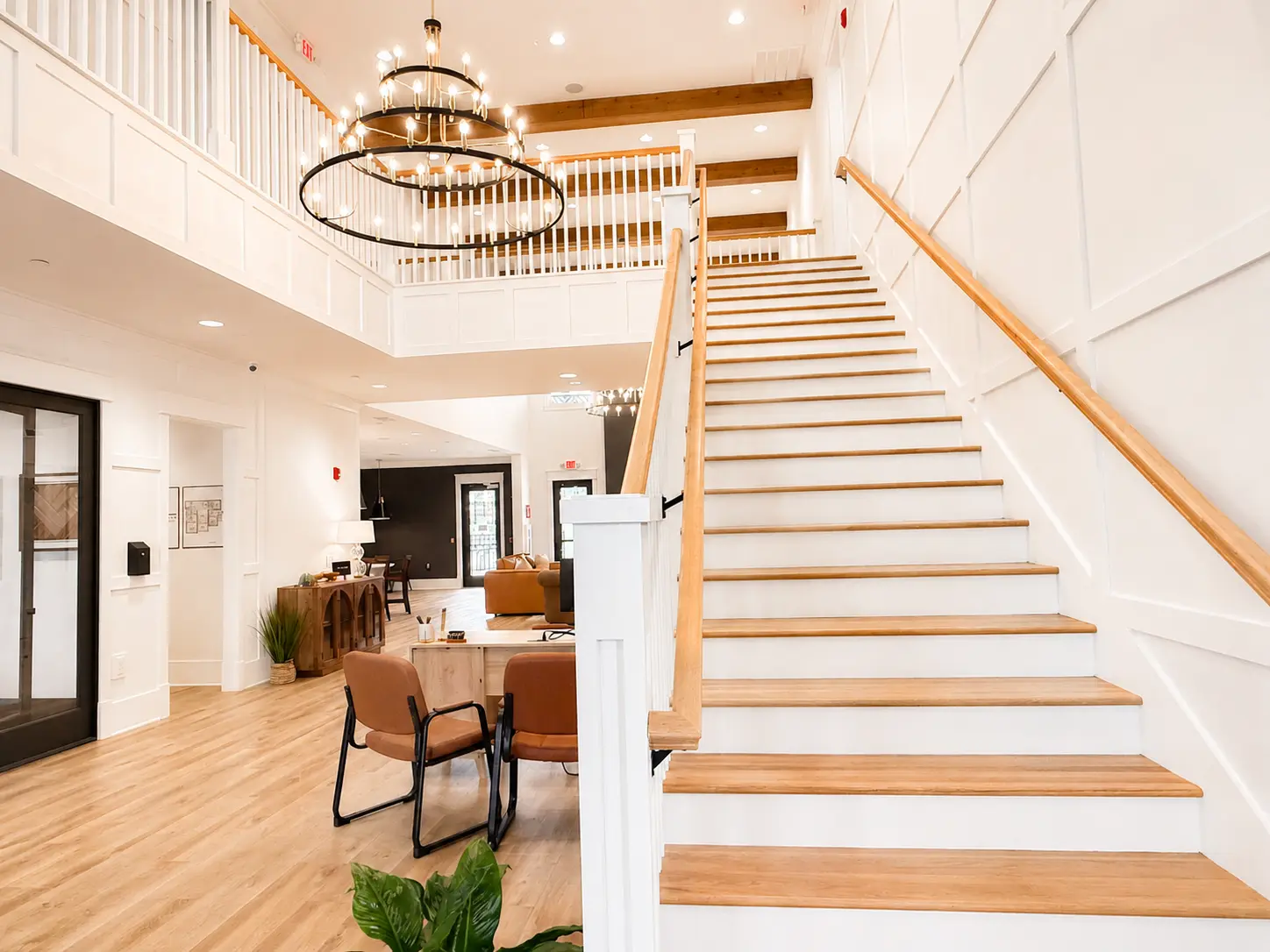 Two-story foyer with white paneled millwork and a custom oak staircase